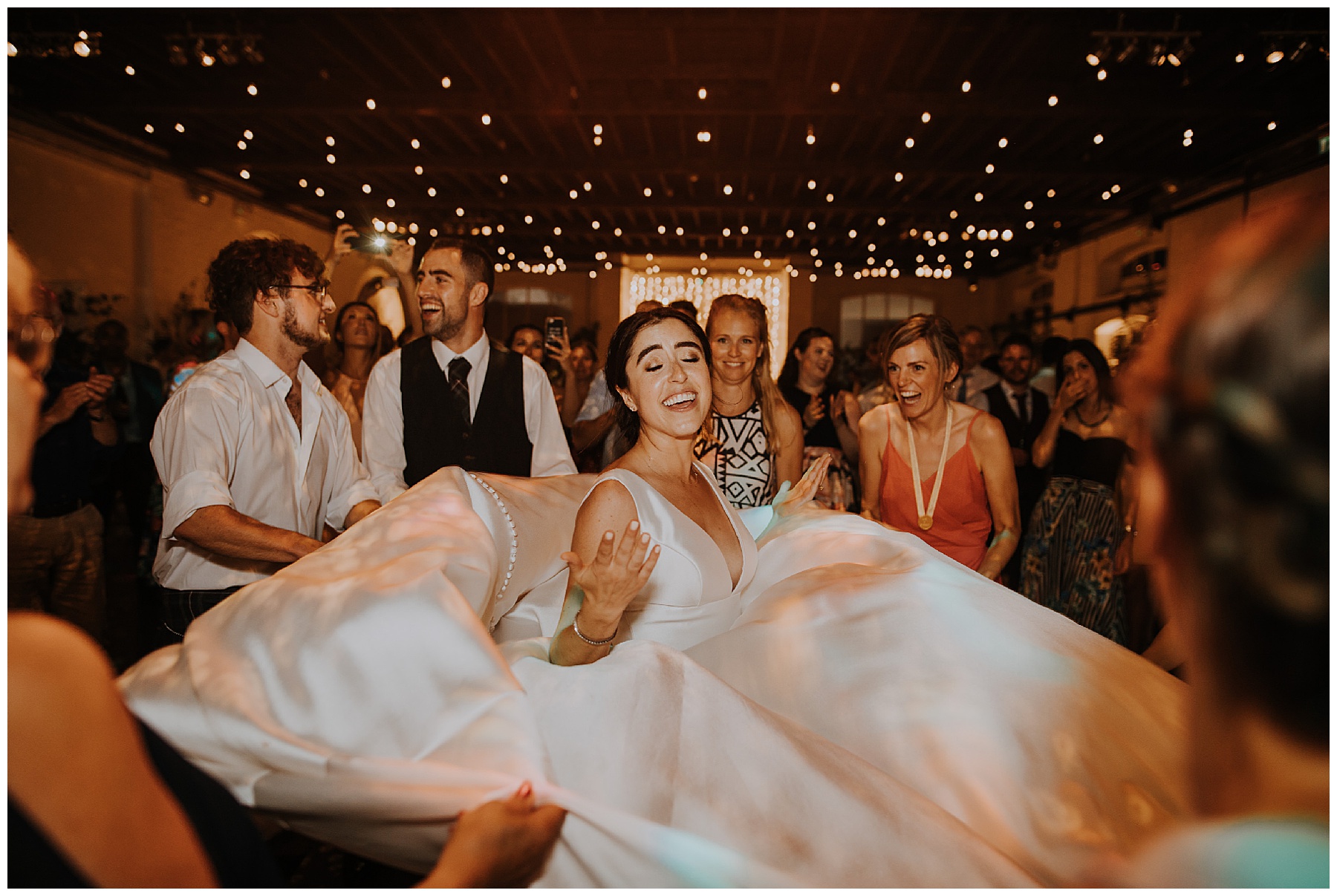 a bride's dress is spun as everyone dances 